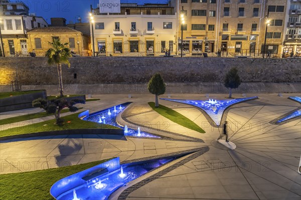 Modern architecture and colourfully lit fountains of Eleftheria Square at dusk, Nicosia, Cyprus,