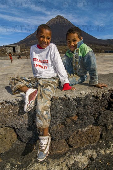 Smiling, happy boys in front of vulcano on Fogo. Cabo Verde. Africa