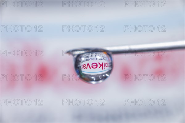 Macro image Covid vaccine, a drop of Moderna vaccine hangs on a vaccine needle