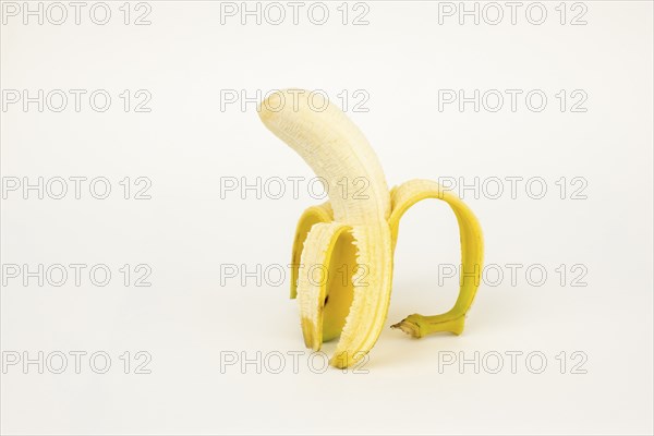 Half peeled banana, studio shot, white background, healthy diet