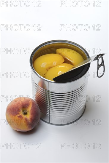 Peach, preserved peach halves with syrup in a tin can