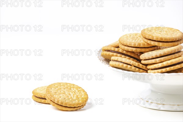 Double biscuits in and next to white bowl, white background, copy space