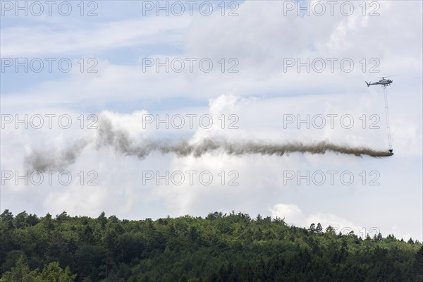 Symbolic image, climate change, helicopter, helicopter spreading finely painted limestone and wood
