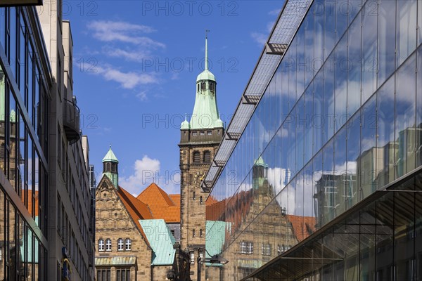 View through Bretgasse to the town hall with the reflection in Galeria Kaufhof