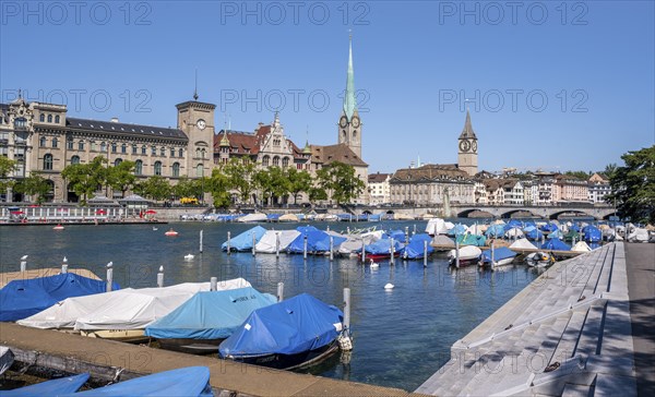 Boats at the jetty in the Limmat, towers of the Fraumünster and St. Peter, Old Town, Zurich,