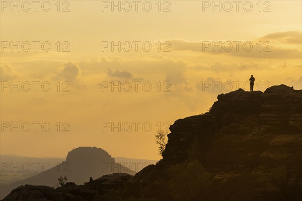 Climbers on the Schrammsteine in the Elbe Sandstone Mountains with the Lilienstein in the