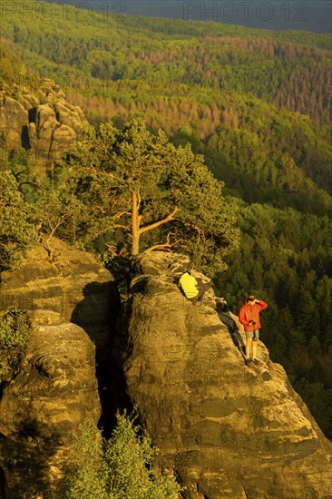 Schrammstein view in the Elbe Sandstone Mountains Looking up the Elbe. Leisurely hikers clamber