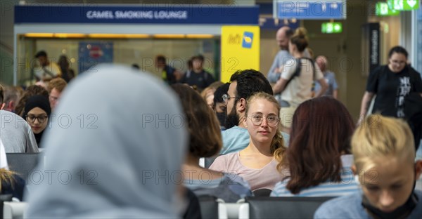 Waiting hall, Young woman waiting for her departure, Check-in, Munich Airport, Bavaria, Germany,