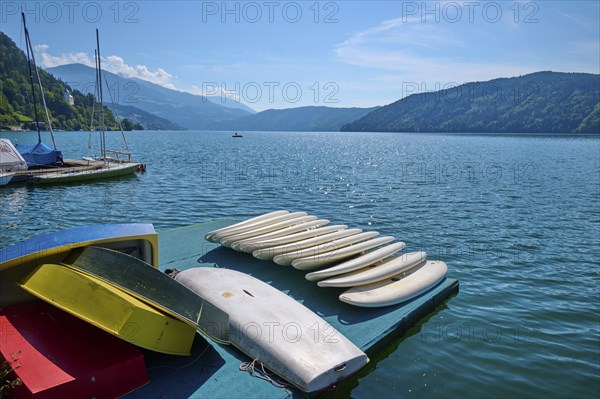 Surfboards, boats, shore, wooden jetty, summer, Lake Millstatt, Millstatt, Carinthia, Austria,