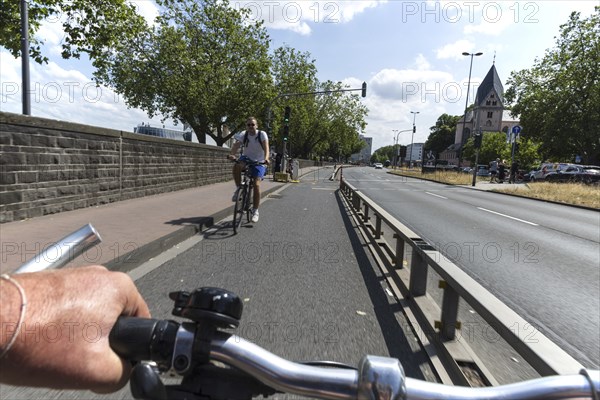 Cycling from a first-person perspective on a cycle path in Cologne, North Rhine-Westphalia,