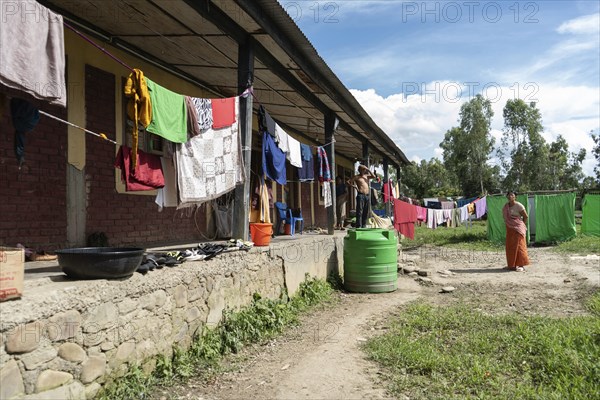 Meitei community man stays in a makeshift shelter after a mob burn their houses during an ethnic