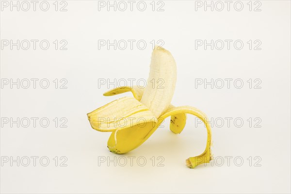 Half peeled banana, studio shot, white background, healthy diet