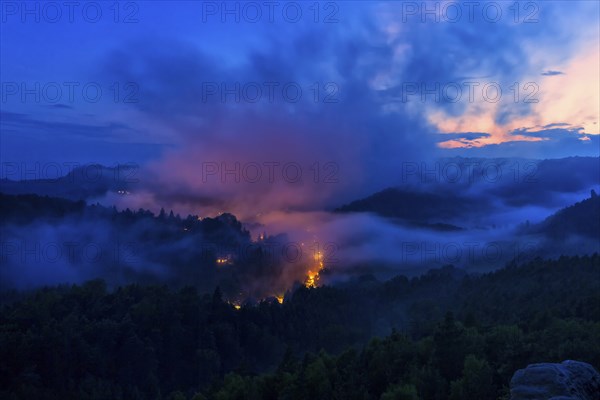 DEU Saxony Rathen Gamrig near Rathen under a full moon in the evening mist The Basteige area with