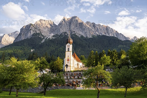 Cemetery and church of St. John the Baptist, mountain peak of the Wetterstein Mountains at the