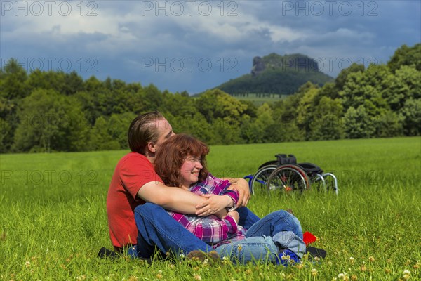 Young couple on the meadows in front of Königstein Fortress