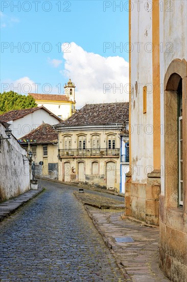 Cobbled streets between historic baroque churches and colonial style houses in the city of Ouro