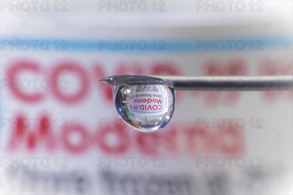 Macro image Covid vaccine, a drop of Moderna vaccine hangs on a vaccine needle