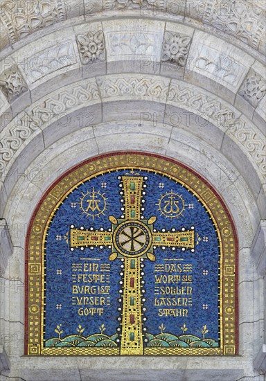 Cross mosaic in the tympanum with the quotation Eine feste Burg ist unser Glauben by Martin Luther,