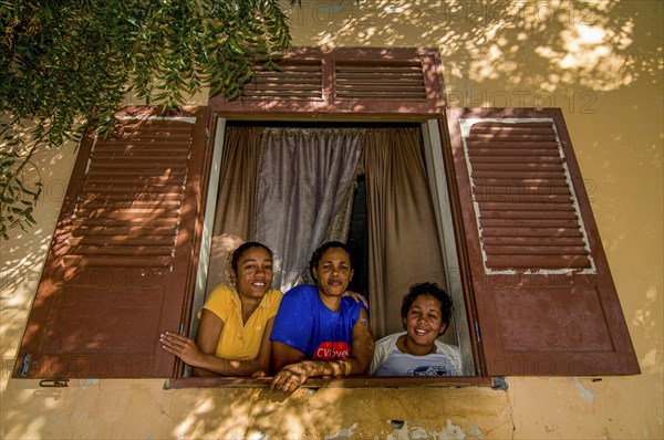 Young women looking out of window. San Felipe. Vulcano Fogo. Fogo. Cabo Verde. Africa
