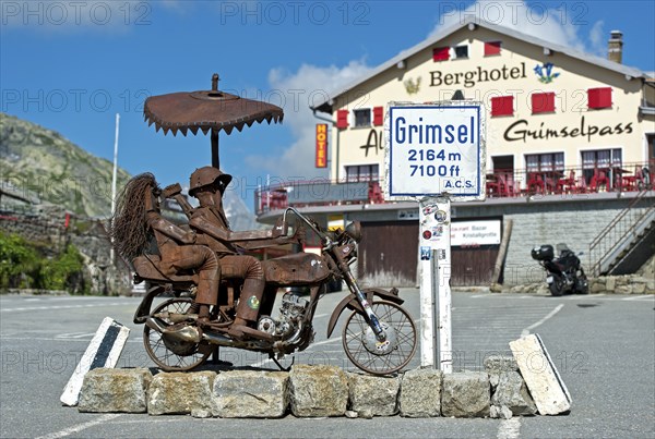 Biker couple, metal sculpture on the Grimsel Pass in front of the Berghotel Alpenlodge Grimselpass,