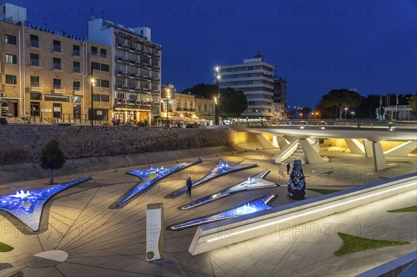 Modern architecture and colourfully lit fountains of Eleftheria Square at dusk, Nicosia, Cyprus,