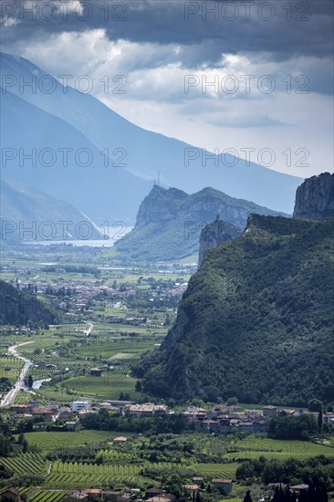 View into the Sarca Valley towards Lake Garda with rocks of Castello di Arco, Garda Mountains,