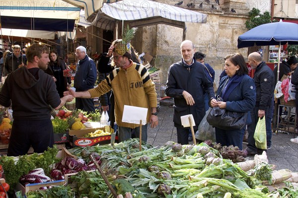 Vegetable and fruit stall, customers, vendor with pineapple as hat, markets, open air, Palermo,