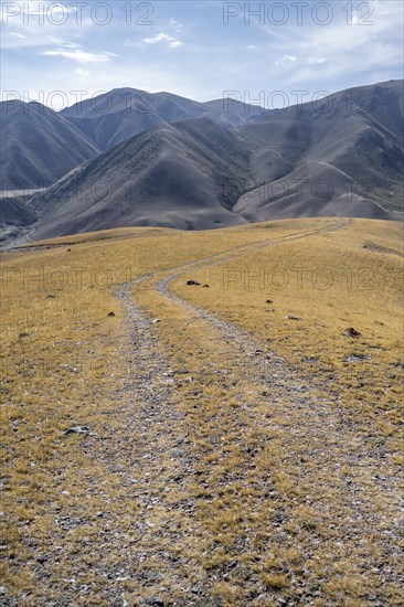 View over eroded mountainous landscape with brown hills, mountains and steppe, Chuy province,