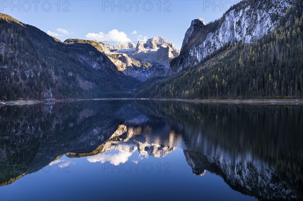 The Vordere Gosausee lake in autumn with a view of the Dachstein mountain range. The Gosaukamm on
