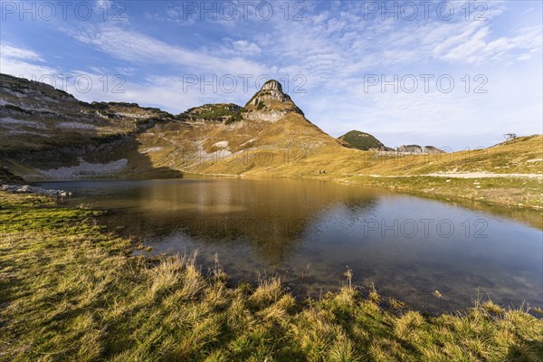 Lake Augstsee and the Atterkogel mountain on the Loser. Autumn, good weather, blue sky. Reflection.