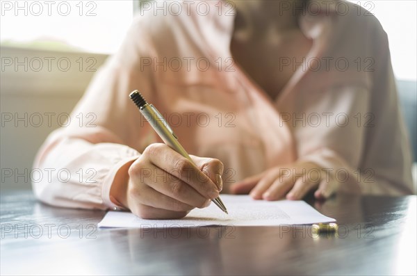 Great concept of divorce, end of relationship, young woman signing divorce agreement