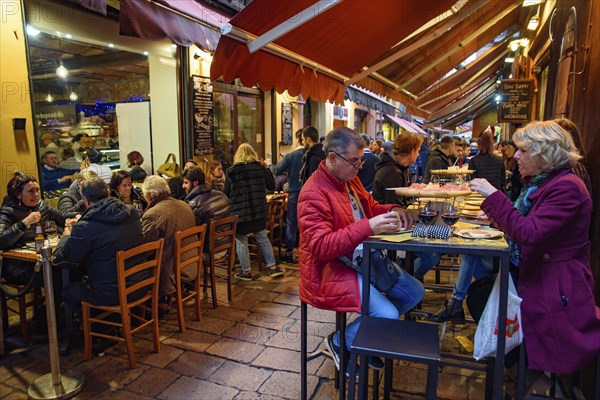 People eating and drinking on the street in Bologna, Italy, Europe