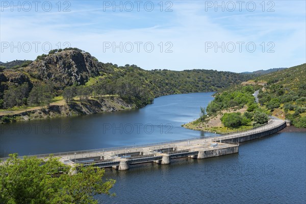 Large dam across a wide river, surrounded by hills and nature, River Tiétar, Tietar, right