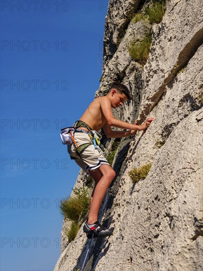 Young climber leading a sport climbing route in the Belove Stene area, island of Krk, Croatia,