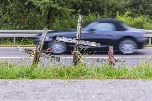 Cross on a country road, symbol of remembrance for three road accident victims. Laichigen,