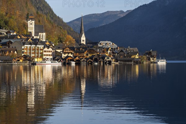 View of Hallstatt and Lake Hallstatt. In the morning in autumn. Good weather, blue sky. Reflection.