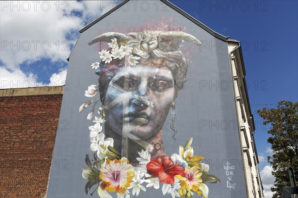 Portrait of a bigender person, bisexuality symbolised by horns and flower arrangement, mural by