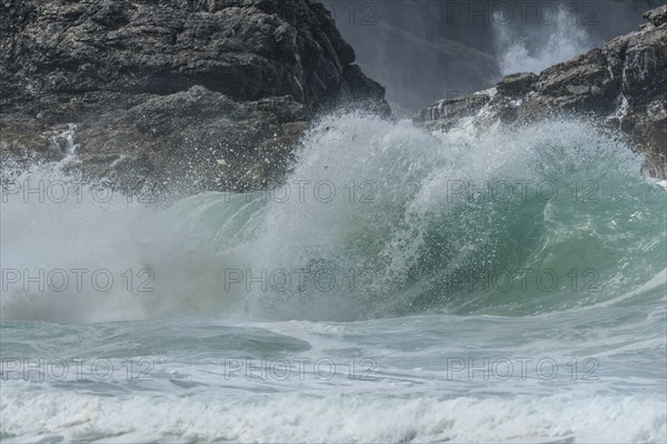 Large waves of the Atlantic Ocean crash against the rocks of a cliff. Camaret sur mer, Crozon,