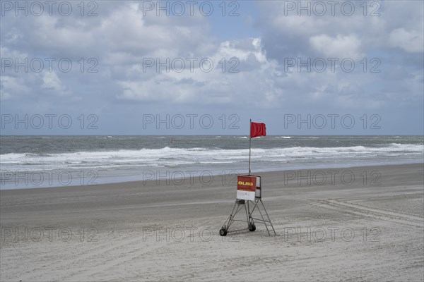 Empty sandy beach on the North Sea coast, DLRG red flag, bathing and swimming prohibited,