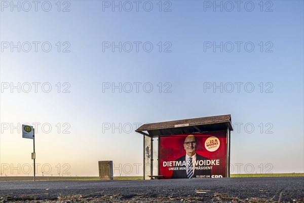 State election in Brandenburg. Bus shelter in an open field with an election poster of Prime