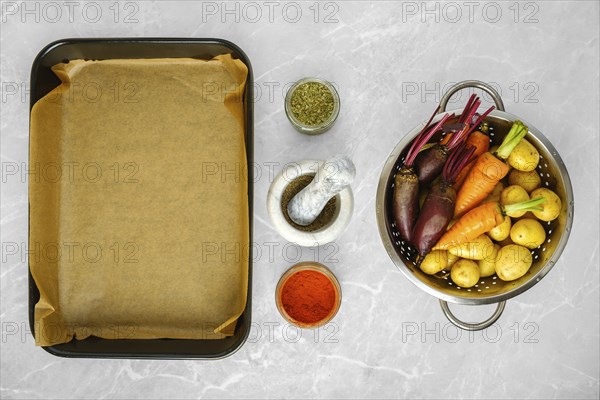 Overhead view of fresh vegetables and spices for baking on kitchen countertop