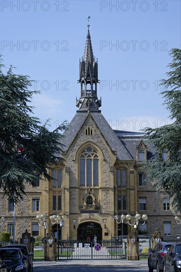 Historic building with Gothic tower and large windows, Fondation Jean-Pierre Pescatore,