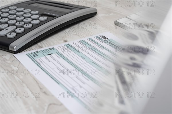 US tax form 1040 with pen and calculator. tax form law document usa white mathematics business