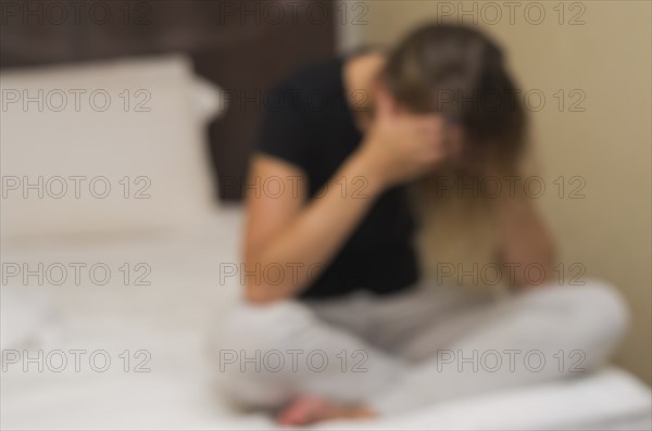 Great concept of depression, sad woman in bed