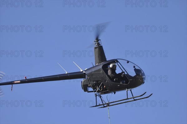 Helicopter lifts a load for a job in Westland, New Zealand, Oceania