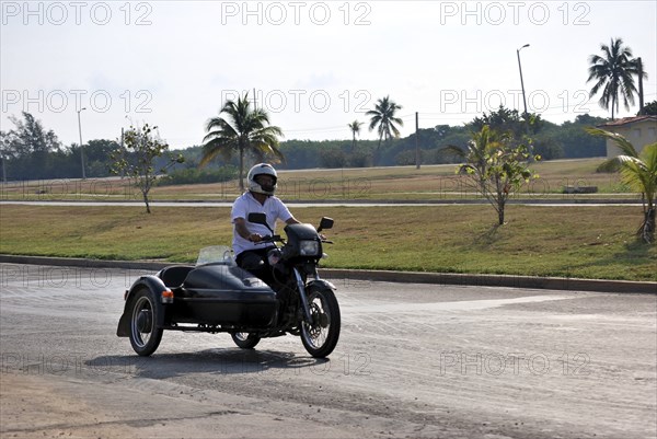 Old sidecar black on a road in Cuba