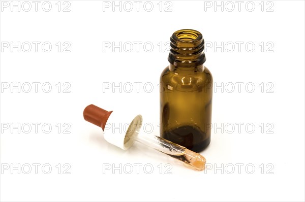 A brown pharmacy bottle with a dropper on a white background