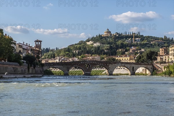 View of Verona historical city centre, Ponte Pietra bridge across Adige river, Verona Cathedral,