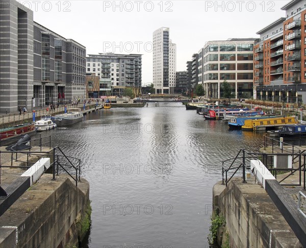 Leeds, west yorkshire, united kingdom, 4 july 2019: a view of leeds dock from the lock gates with