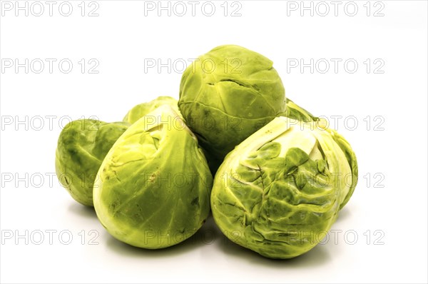 A pile of Brussels sprouts on a white background